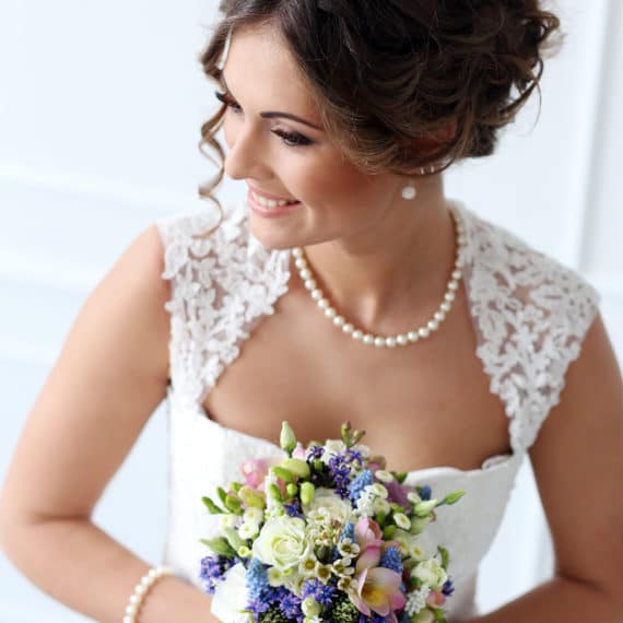 Bride wearing a wedding dress with a queen anne neckline on the JoSaBi blog