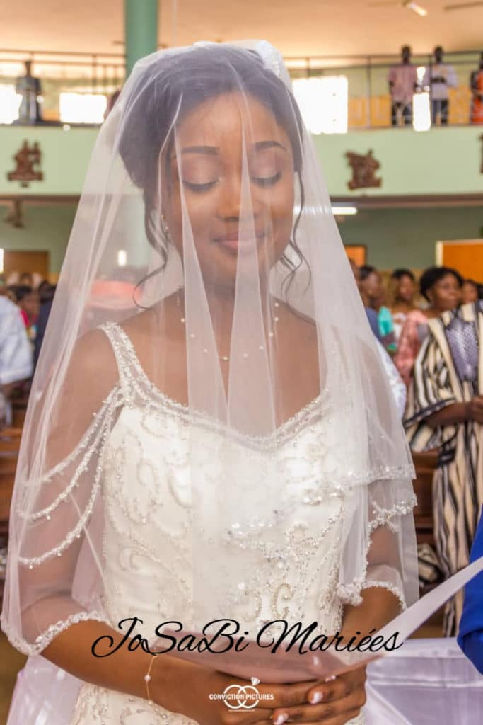 Bride wearing a custom ivory JoSaBi Mariées wedding dress