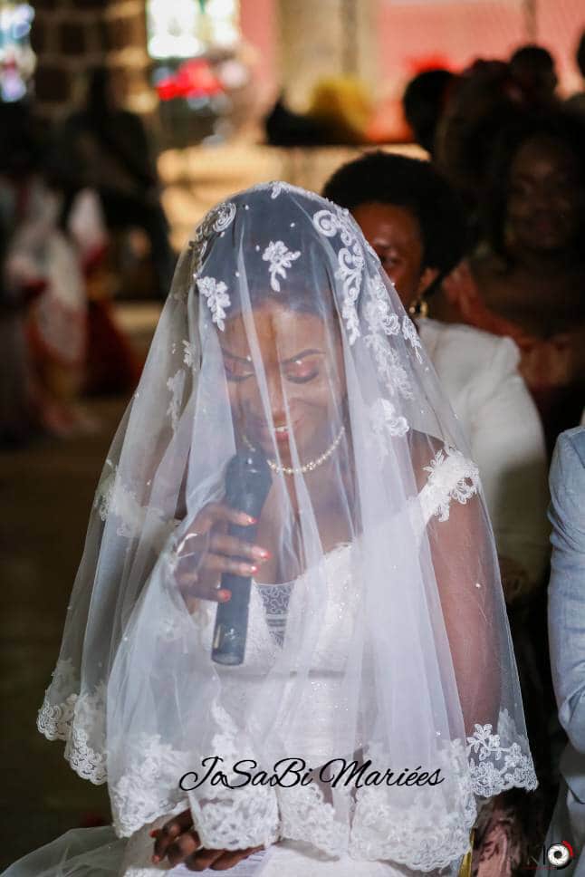 Laetitia wearing a custom JoSaBi wedding dress and veil on her wedding day