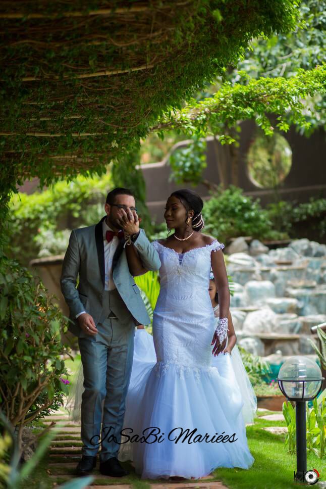 Laetitia wearing a custom wedding dress and her husband on their wedding day