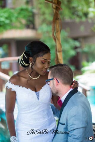 Laetitia wearing a custom JoSaBi wedding dress and her husband on their wedding day