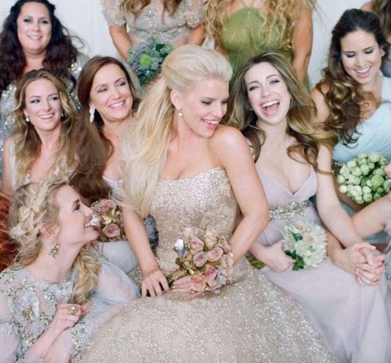Jessica Simpson smiling with her bridesmaids on her wedding day