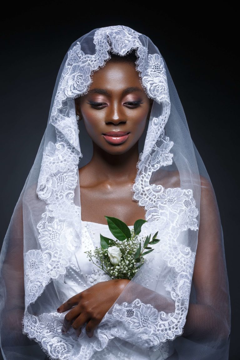 black woman wearing a white mantilla veil