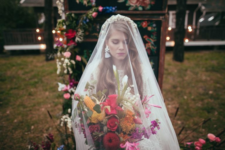 Boho bride with chapel length drop veil