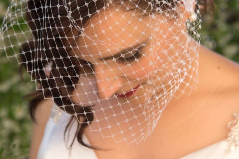 Bride with birdcage length veil