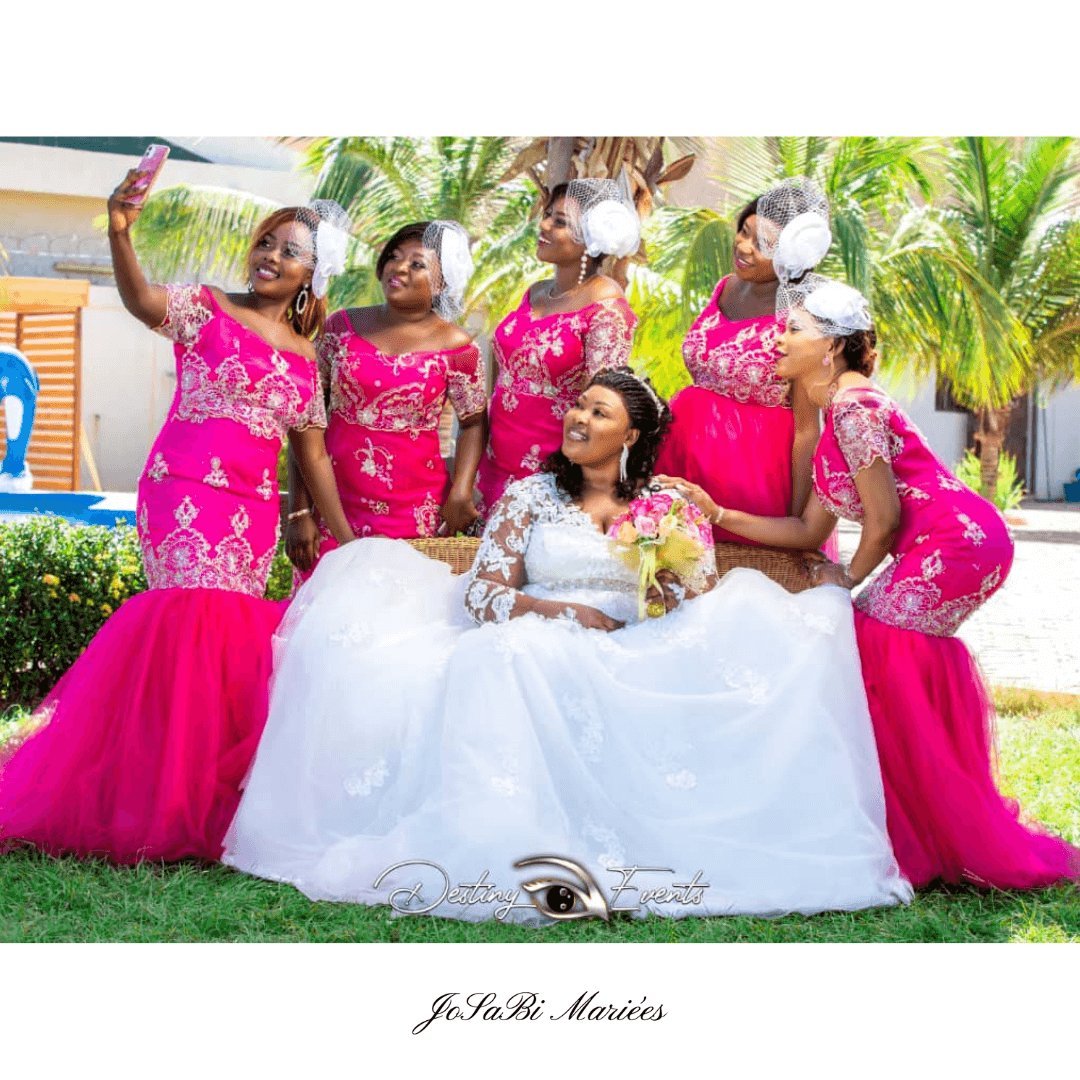 Beautiful smiling bride surrounded by her bridesmaids